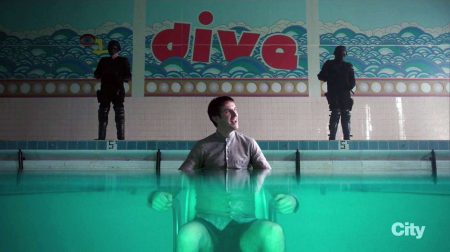 in a few seconds, David will actually follow the wall inscription’s imperative and take a dive to save his life. (Also note the optical distortion-slash-illusion created by the underwater-part of the shot that has David’s lower body magnified, which could be read as visual metaphorization of David’s schizophrenia – two personas in one body.