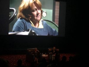 Fig. 4: Val Lehman and Jane Clifton in conversation, with Lehman's character, 'top dog' Bea Smith, on the big screen at 'On the Inside: 40 Years of Prisoner', 2019 St Kilda Film Festival, Melbourne